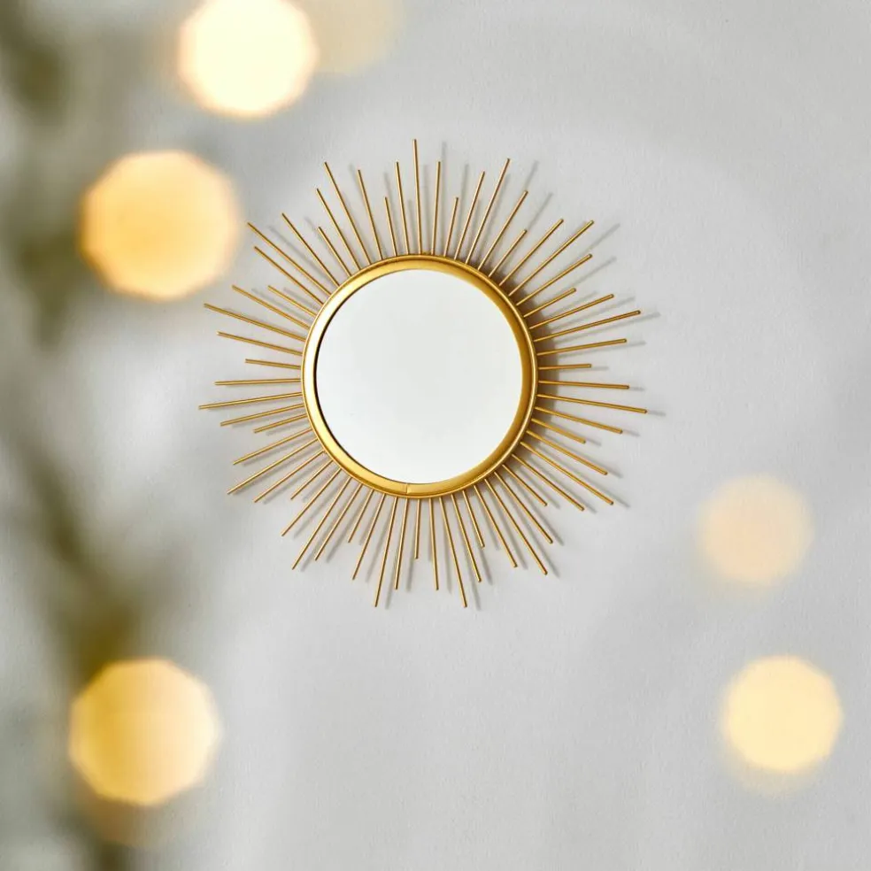 Miroir forme soleil en métal doré
